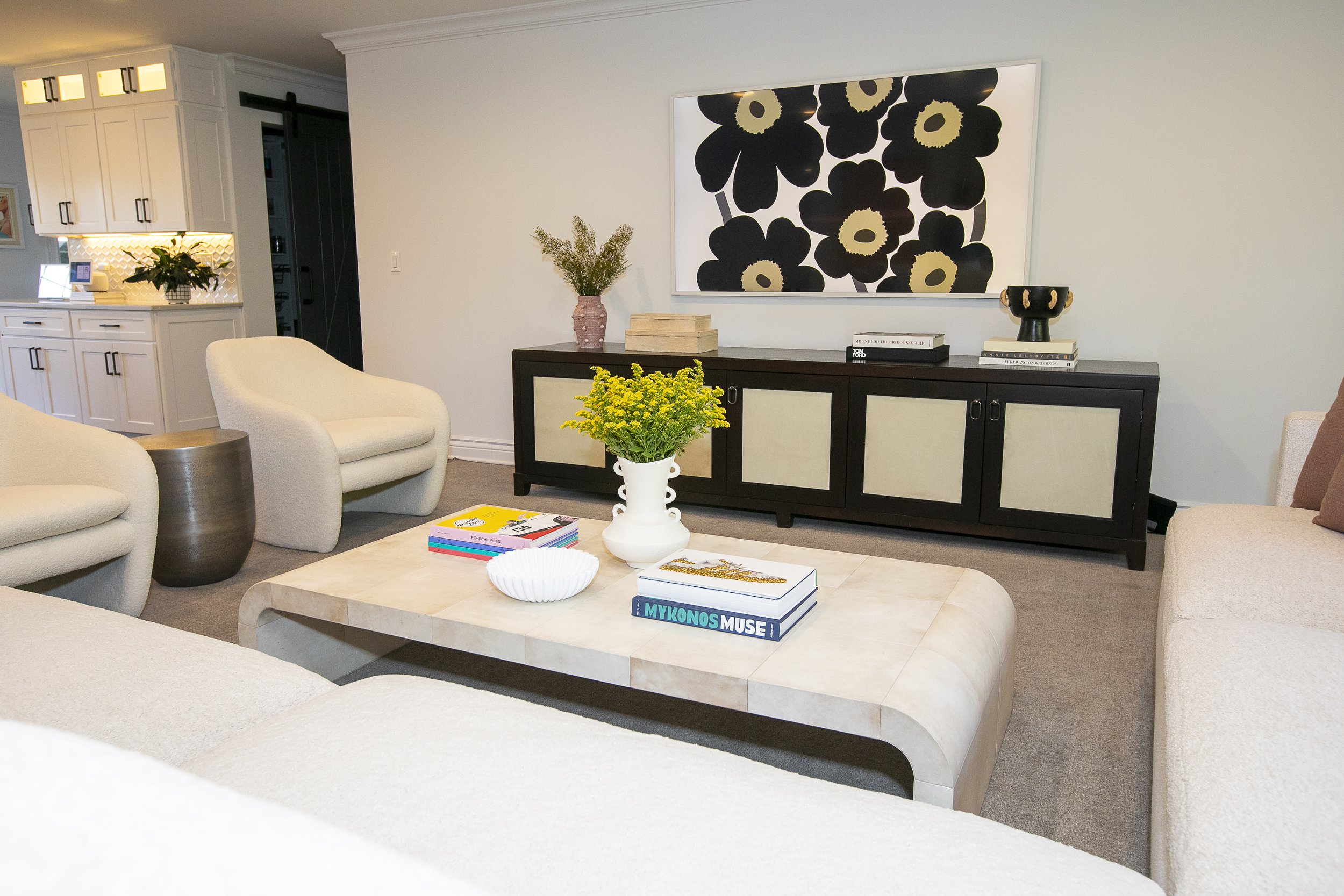 This room has a modern, sophisticated style with a minimalist approach and subtle, mid-century influences. The palette is neutral and earthy, creating a calm and refined ambiance