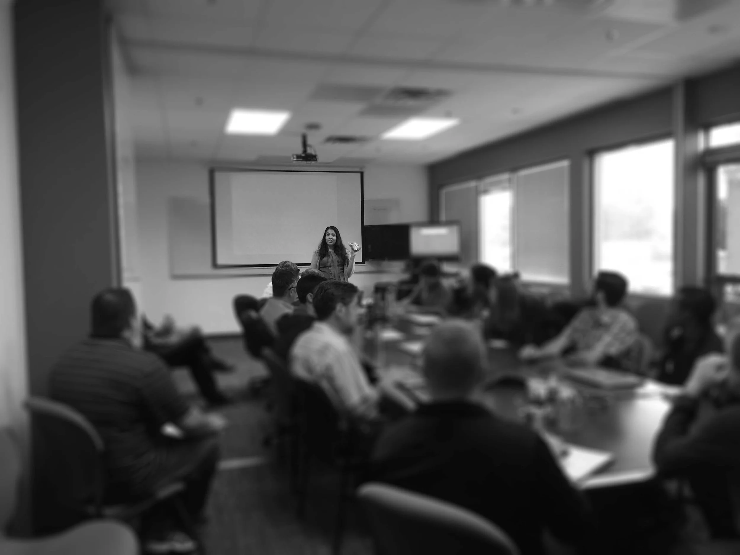 A woman coaching in a conference room.