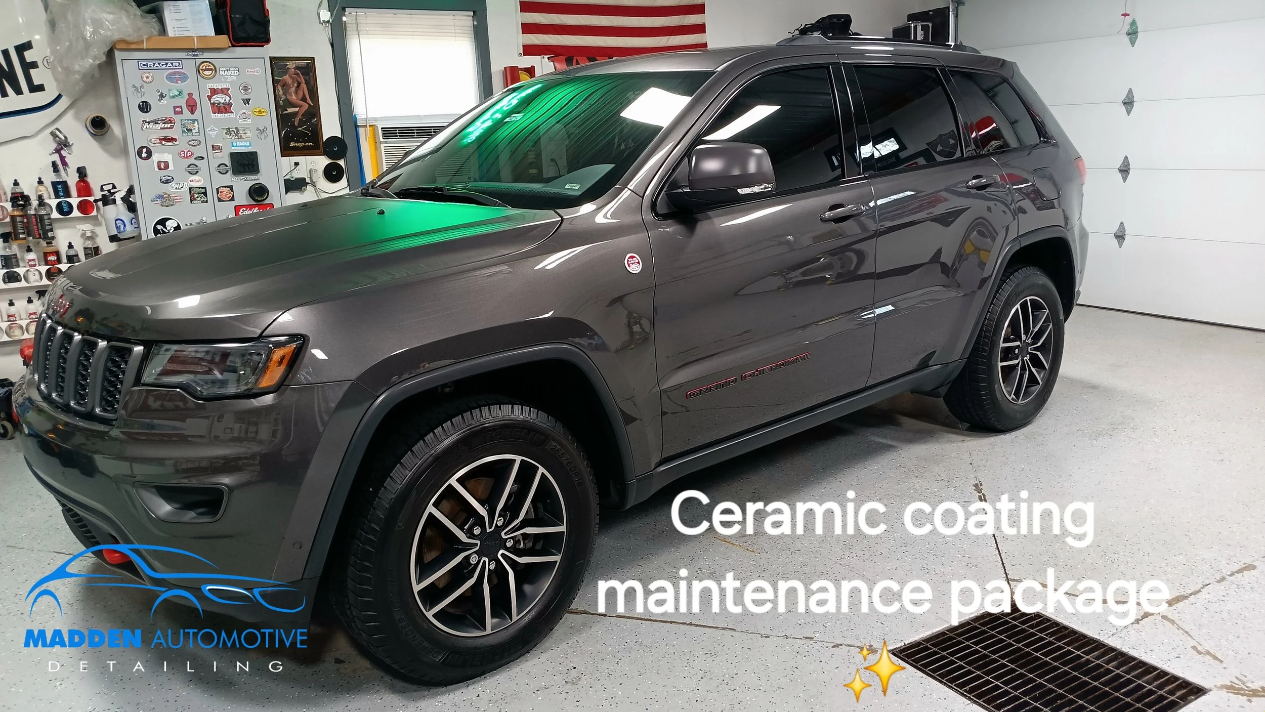 Gray Jeep Grand Cherokee inside a garage with automotive supplies on the wall, an American flag, and a closed garage door. Text overlay reads 'Ceramic coating maintenance package'.