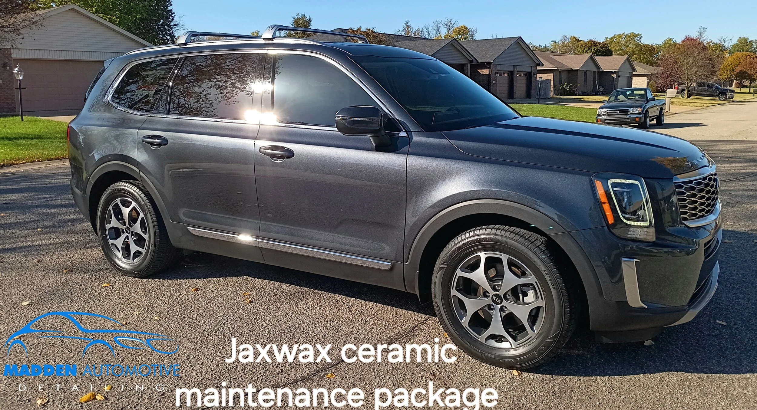 SUV in driveway with "Jaxwax ceramic maintenance package" and "Madden Automotive Detailing" text, clear sunny day.