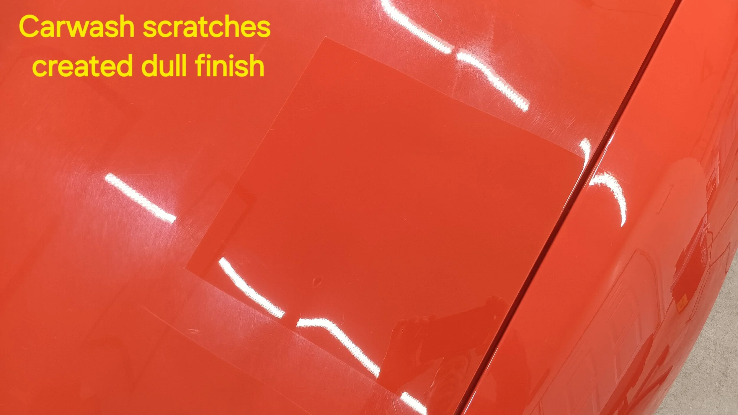 Orange car with scratches creating a dull finish, as indicated by the yellow text that says "Carwash scratches created dull finish".