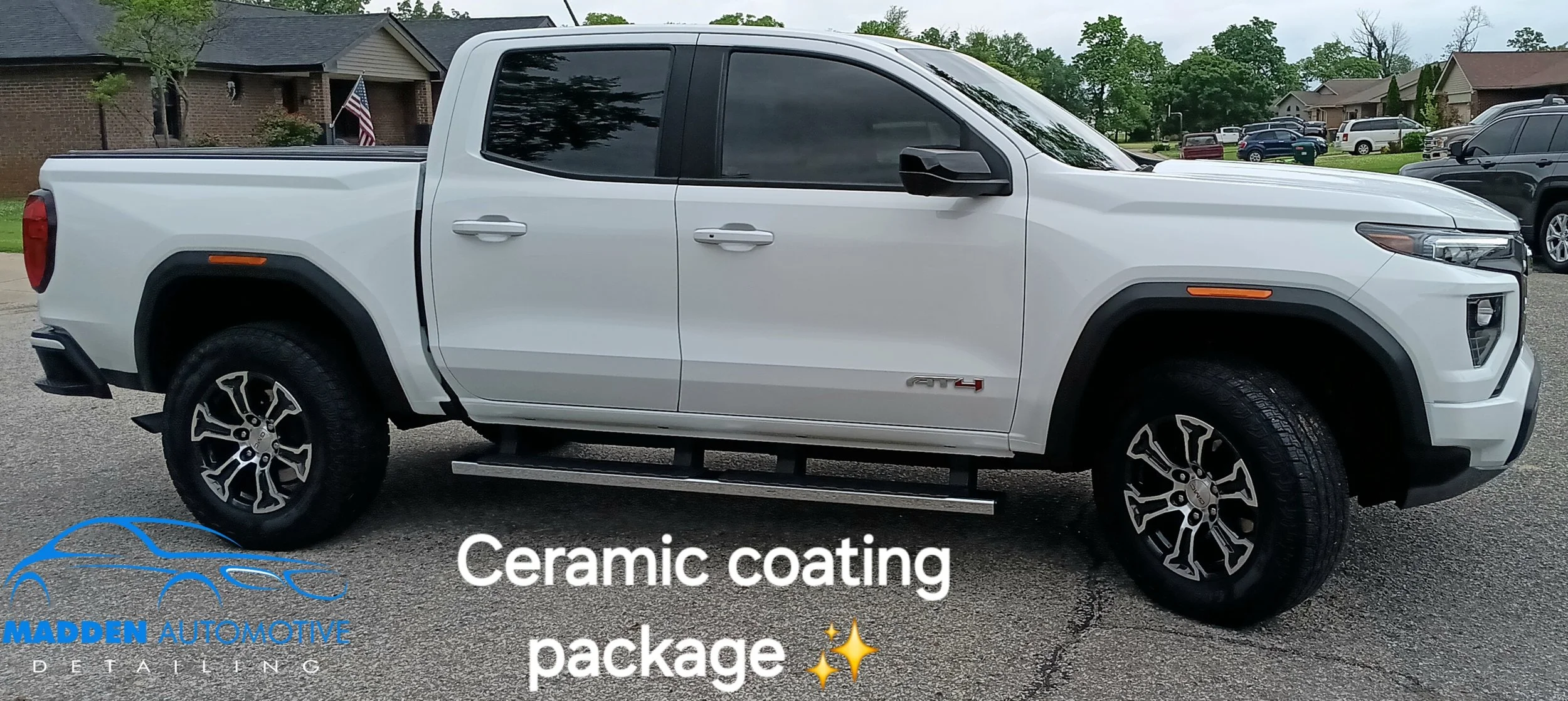 White pickup truck parked in a lot with houses in the background, advertised for ceramic coating service by Madden Automotive Detailing.