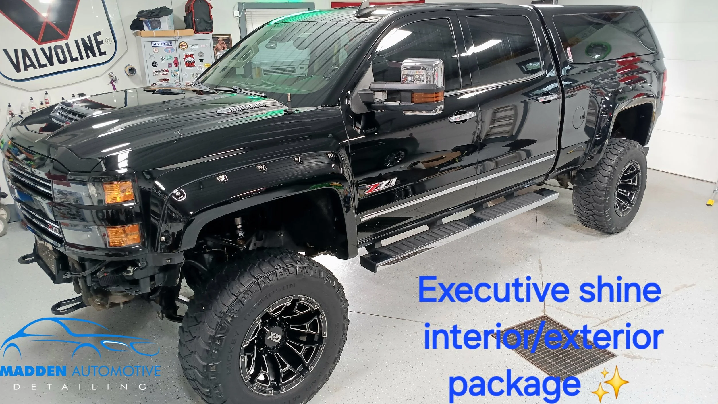 Black pickup truck inside a garage with Madden Automotive Detailing logo; text overlay reads 'Executive shine interior/exterior package' with sparkle emojis.