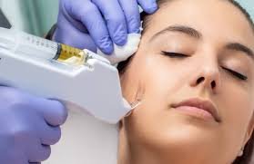 A woman receiving a facial treatment with a syringe, administered by a professional wearing purple gloves.