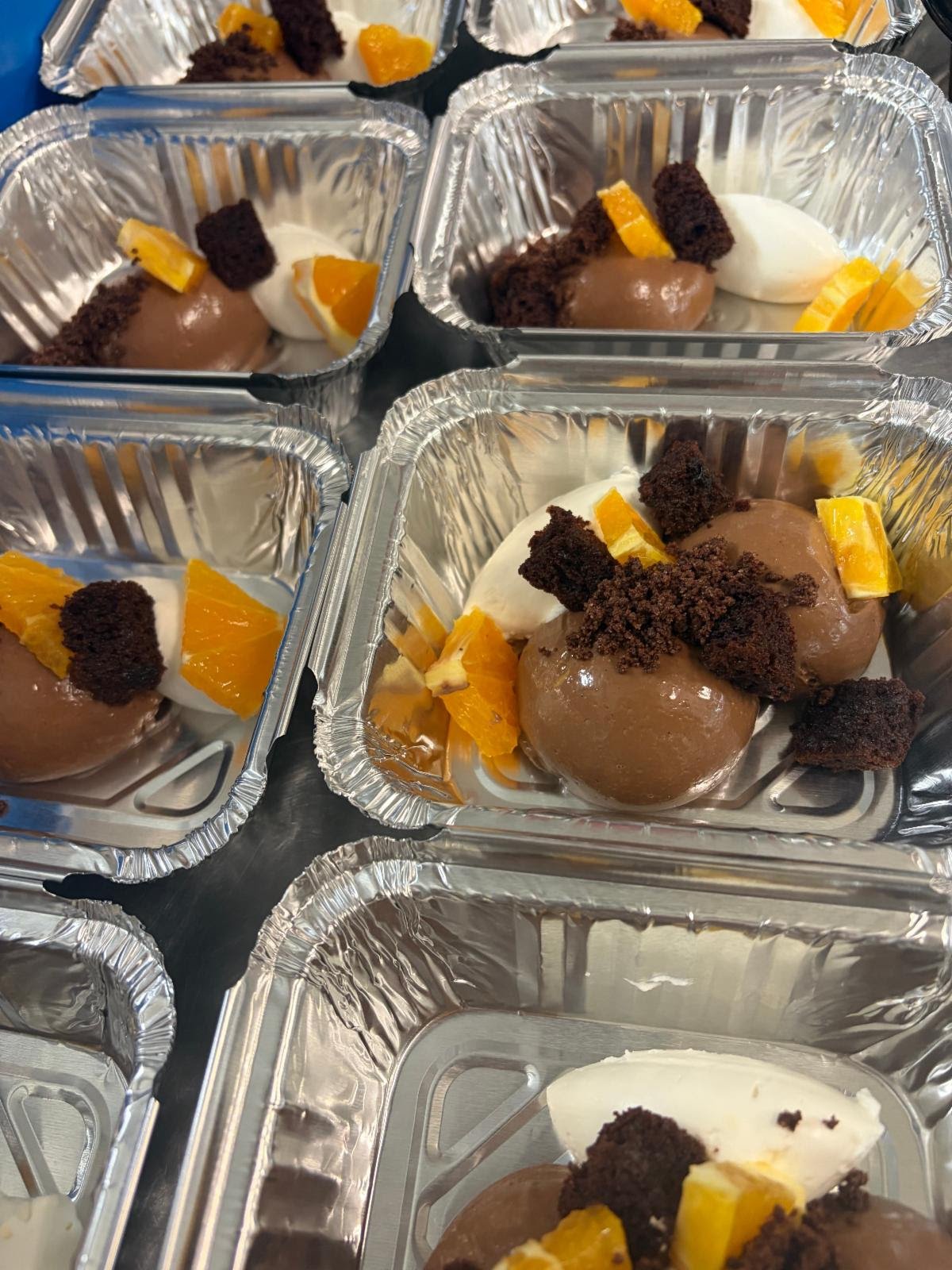 Chocolate and vanilla mousse garnished with fresh orange wedges and chocolate shavings