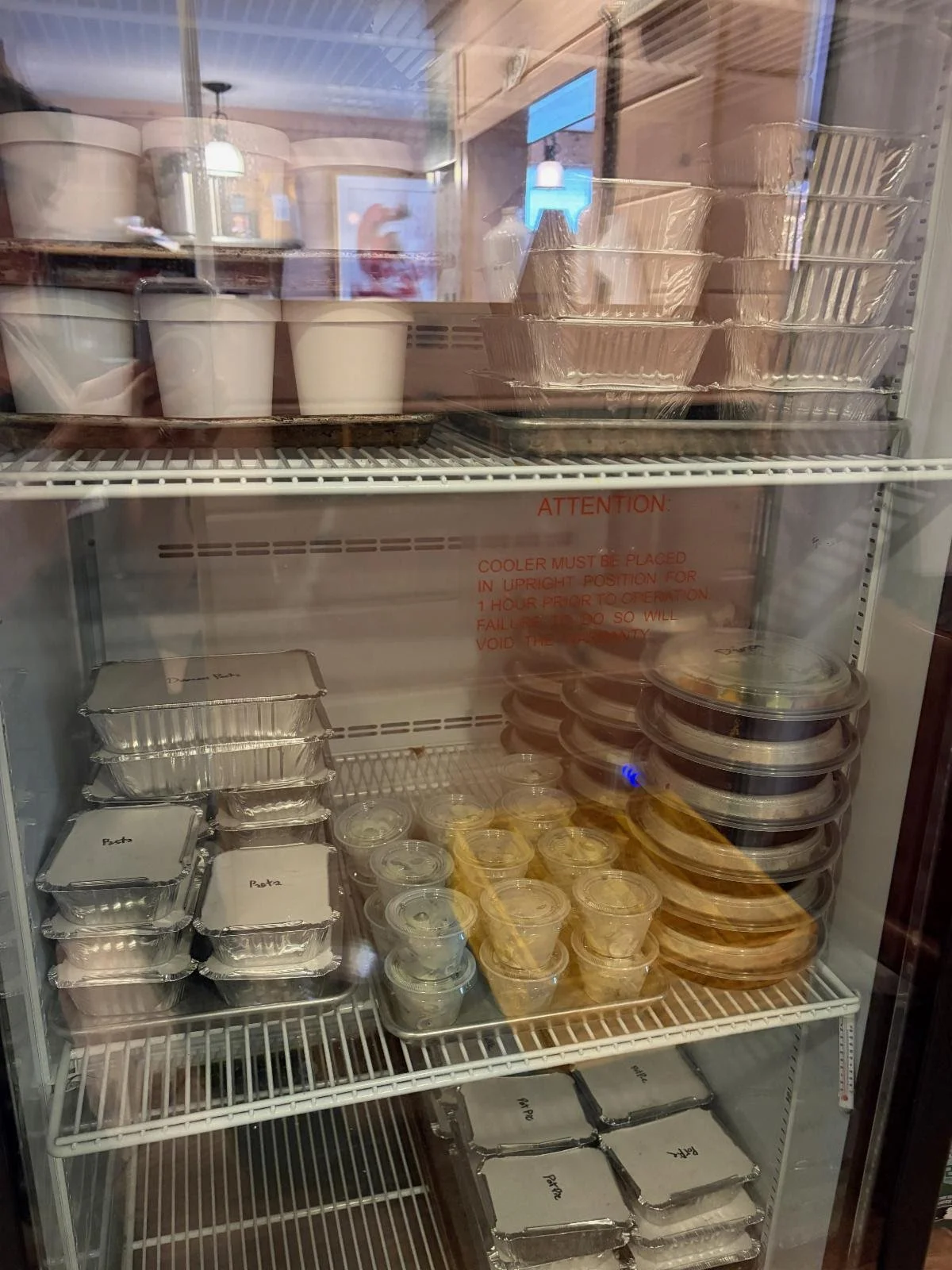 Glass door fridge with meals prepared and organized on shelves