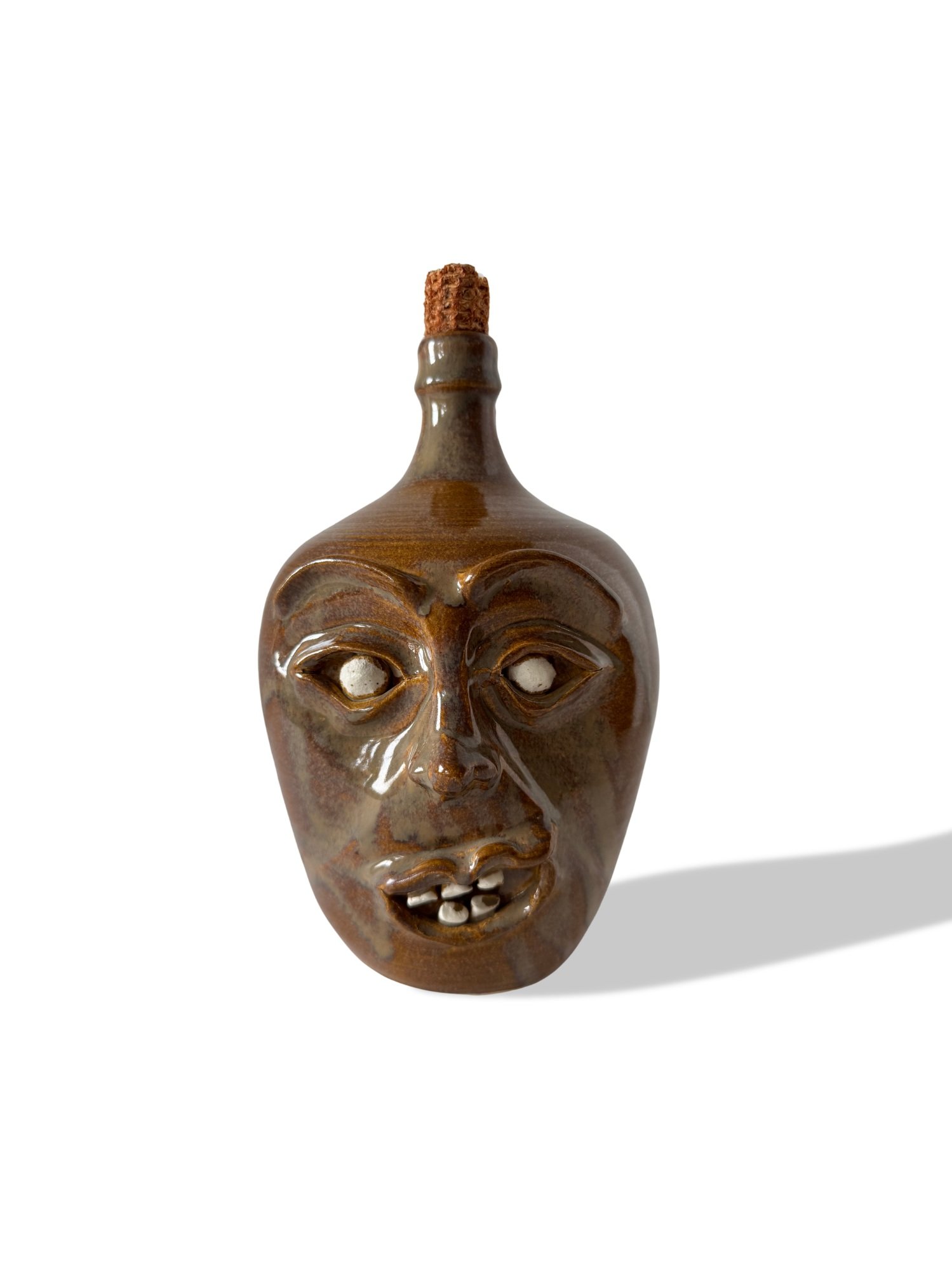 Signed folk art ceramic jug by J. Daves, dated May ’93. Ugly jug style with exaggerated eyes and teeth. Sculptural and expressive. Available at Studio TMS Chicago.
