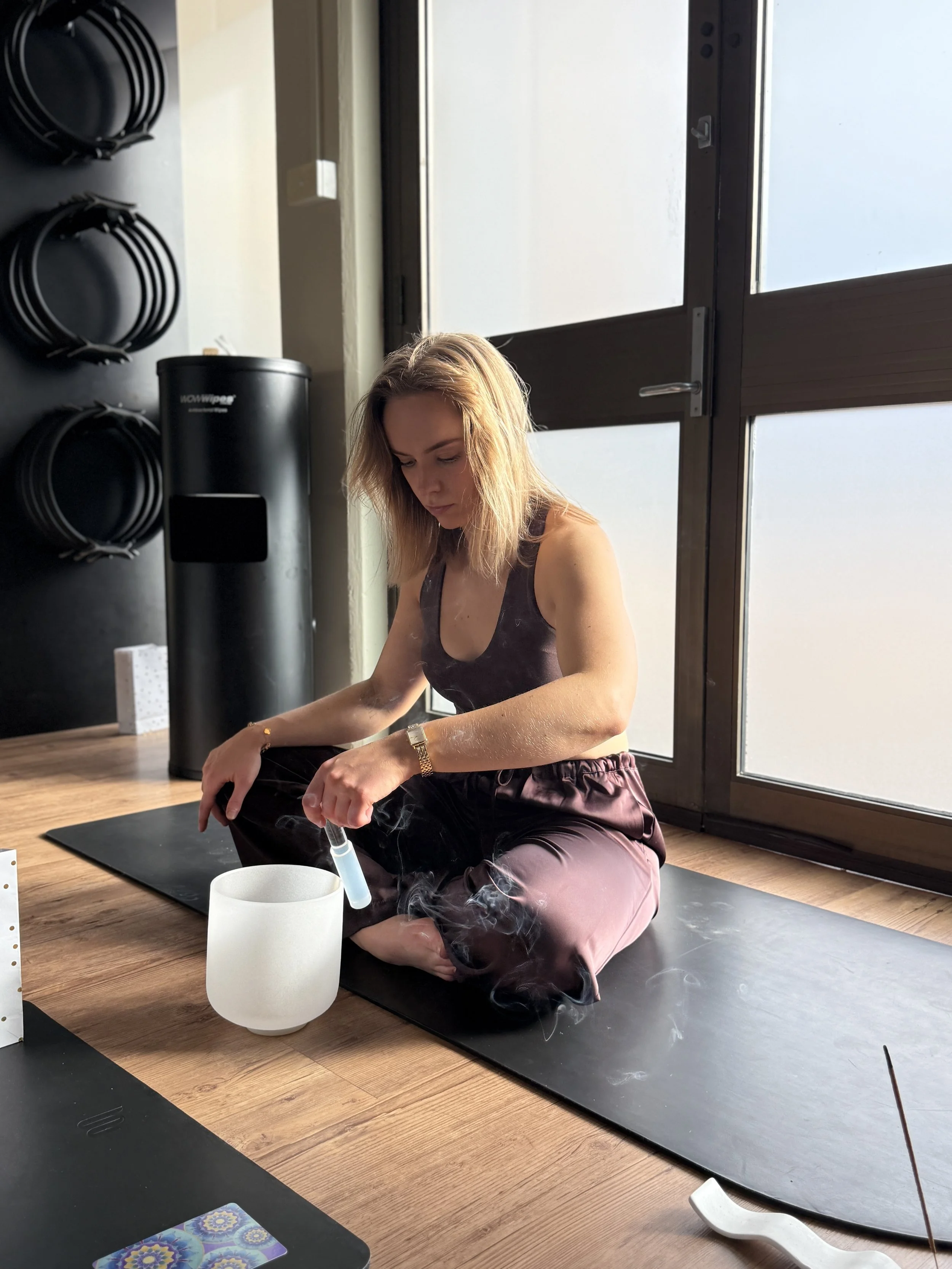 Breathwork instructor ringing sound bowl at breathwork class in Hobart, Tasmania