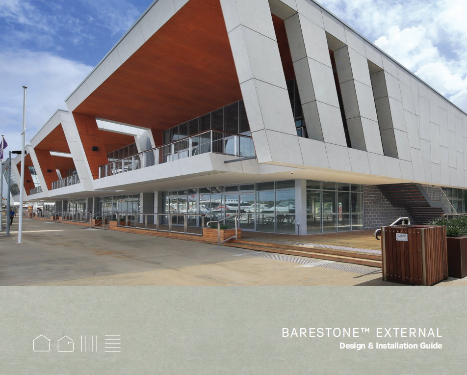 Modern building with large angular overhangs, glass windows, and outdoor wooden deck, situated at a waterfront or marina area.