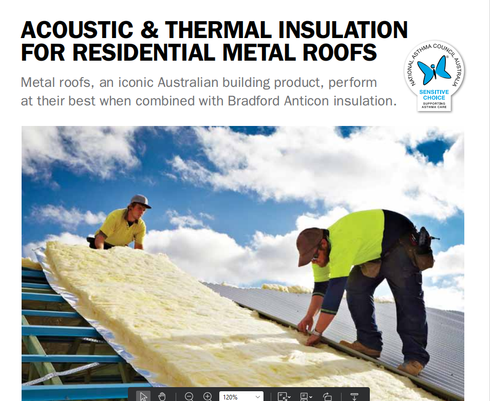 Two workers installing thermal insulation on a metal roof, with clouds and blue sky in the background.