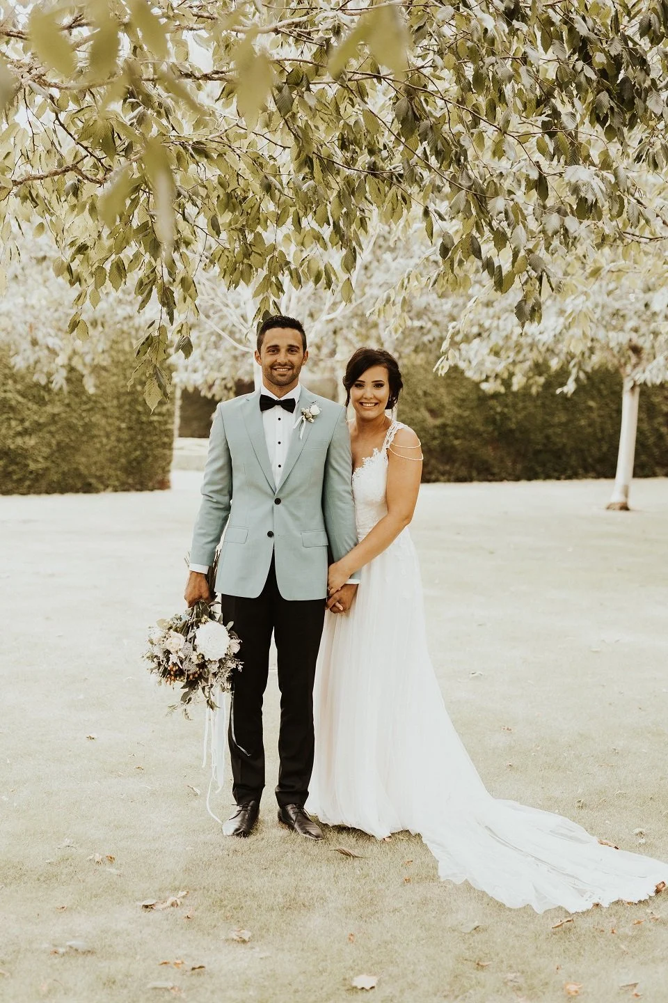Bride and groom stands under silver birch trees from Charlotte & Byron's wedding at Trott’s Garden photographed by Charlotte Sowman Photography