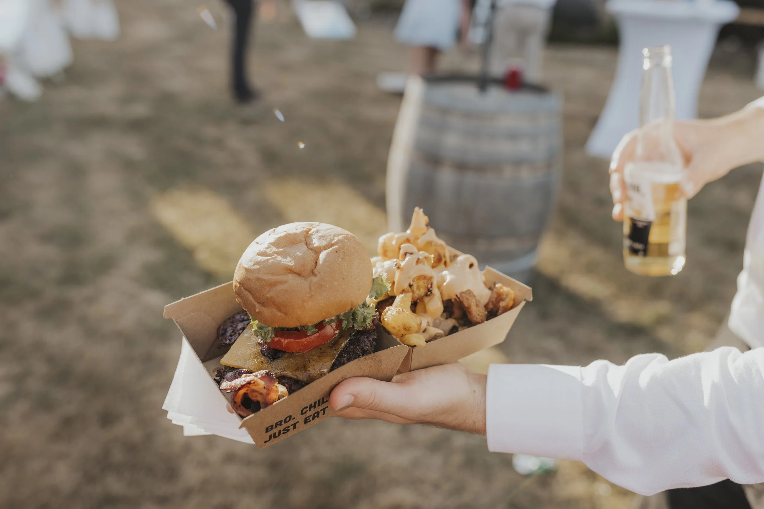 take-away burger wedding catering with beer from Kylie and Nick's wedding at a golden field photographed by Sophie Isabella Photo