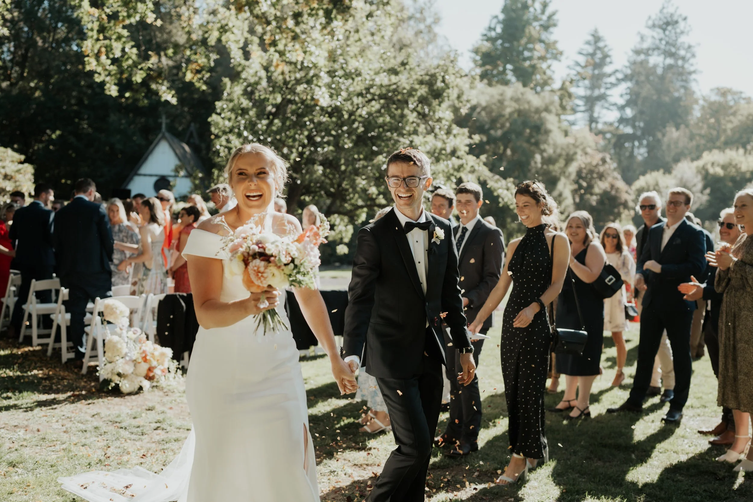 bride and groom walking through confetti from Rebecca and Fraser's wedding at Longbeach Estate photographed by Sarah Clements Photography