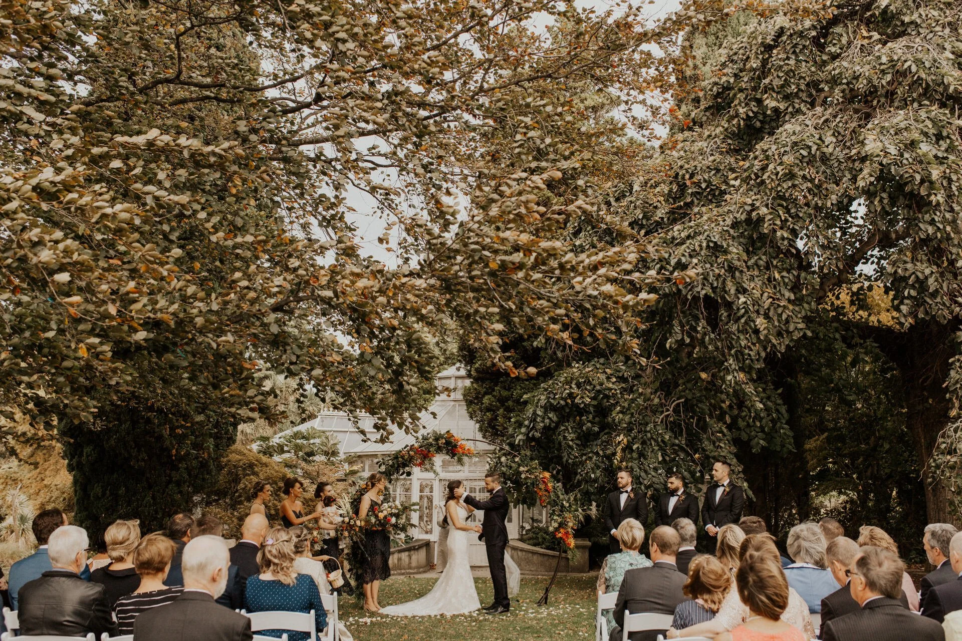 Bride and groom at the altar with floral arch from Claire & Hamish's wedding at Mona Vale Homestead photographed by Susannah Blatchford Photography