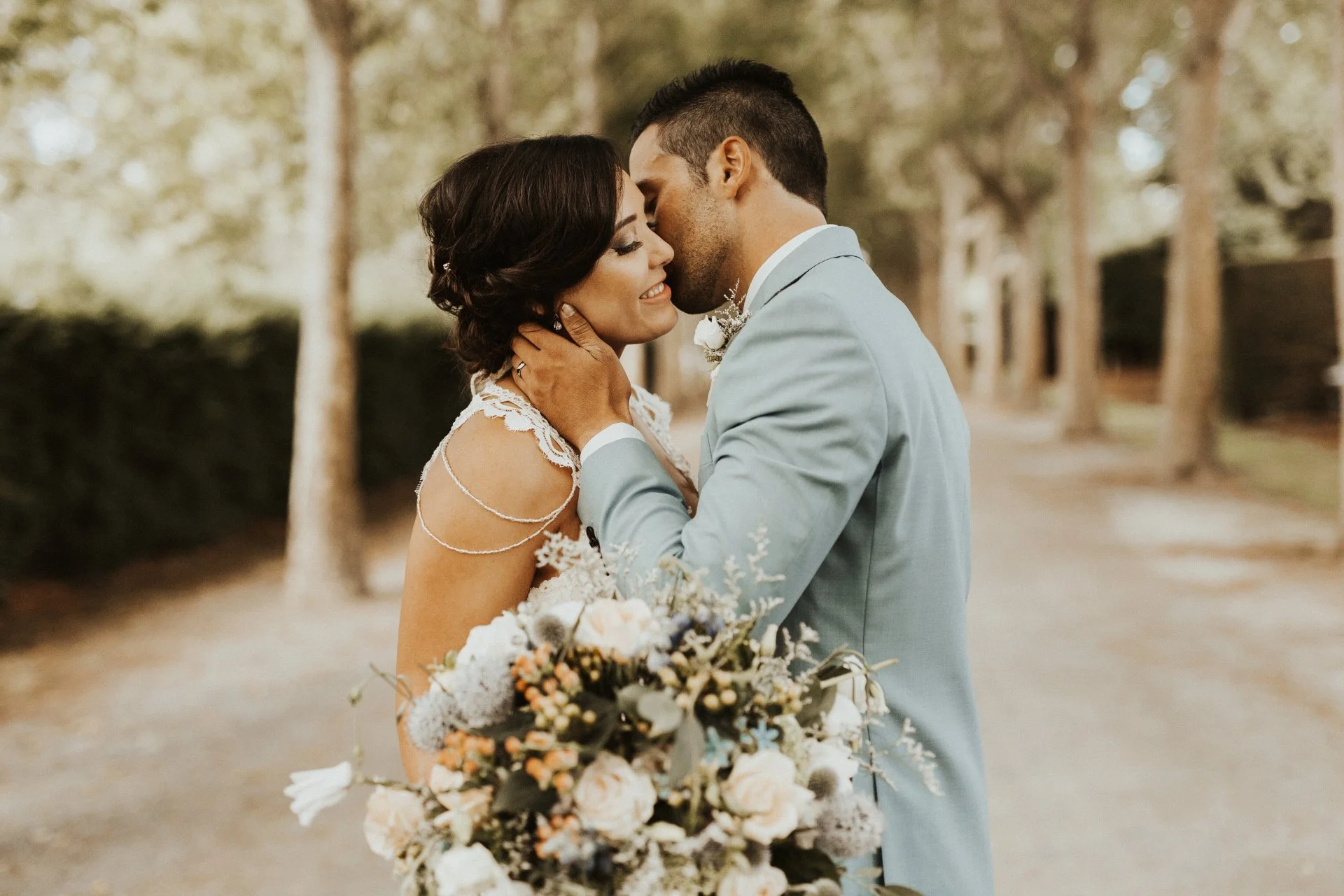 bride and groom kissing in tree lined lane from Charlotte & Byron's wedding at Trott’s Garden photographed by Charlotte Sowman Photography