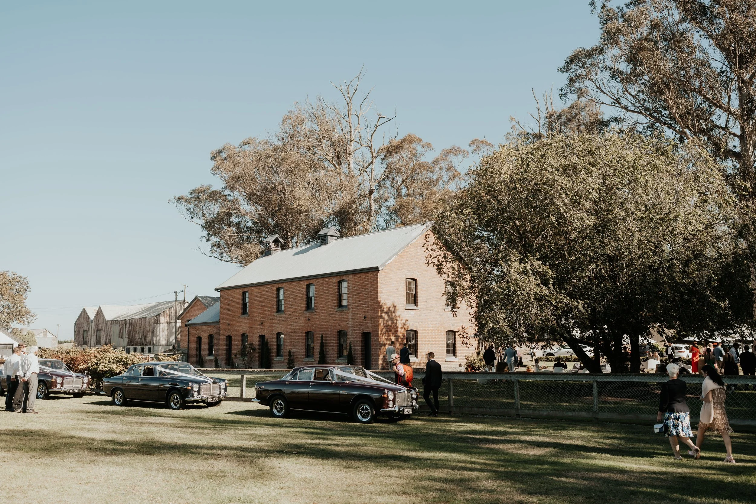 Vintage car wedding transport in front of brick building from Rebecca and Fraser's wedding at Longbeach Estate photographed by Sarah Clements Photography