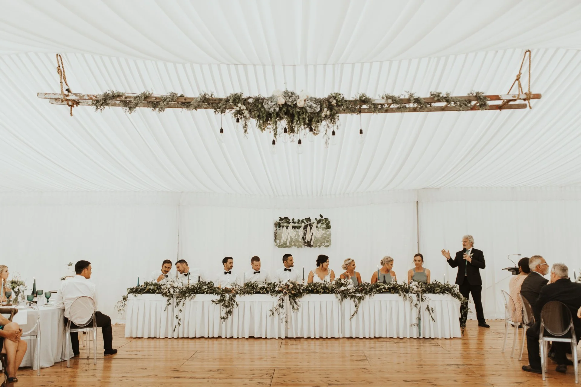 wedding reception head table inside elegant white marquee from Charlotte & Byron's wedding at Trott’s Garden photographed by Charlotte Sowman Photography