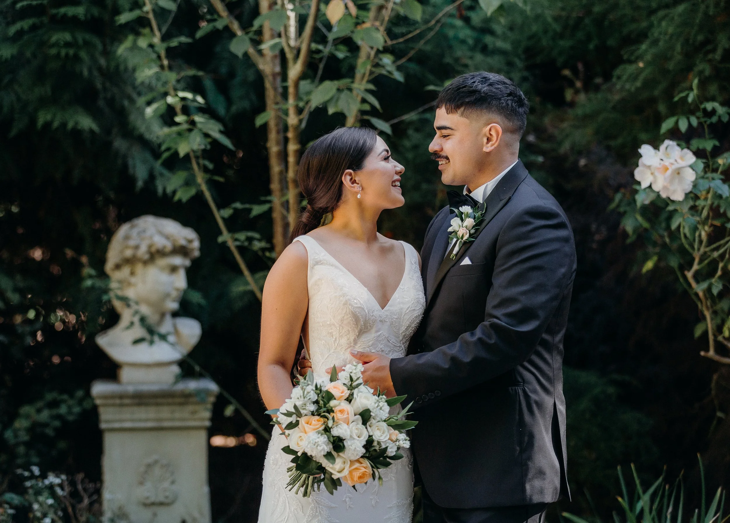 Bride and groom with bouquet from Olivia and Tukorehu's wedding at Pemberton Gardens photographed by Koru Photography