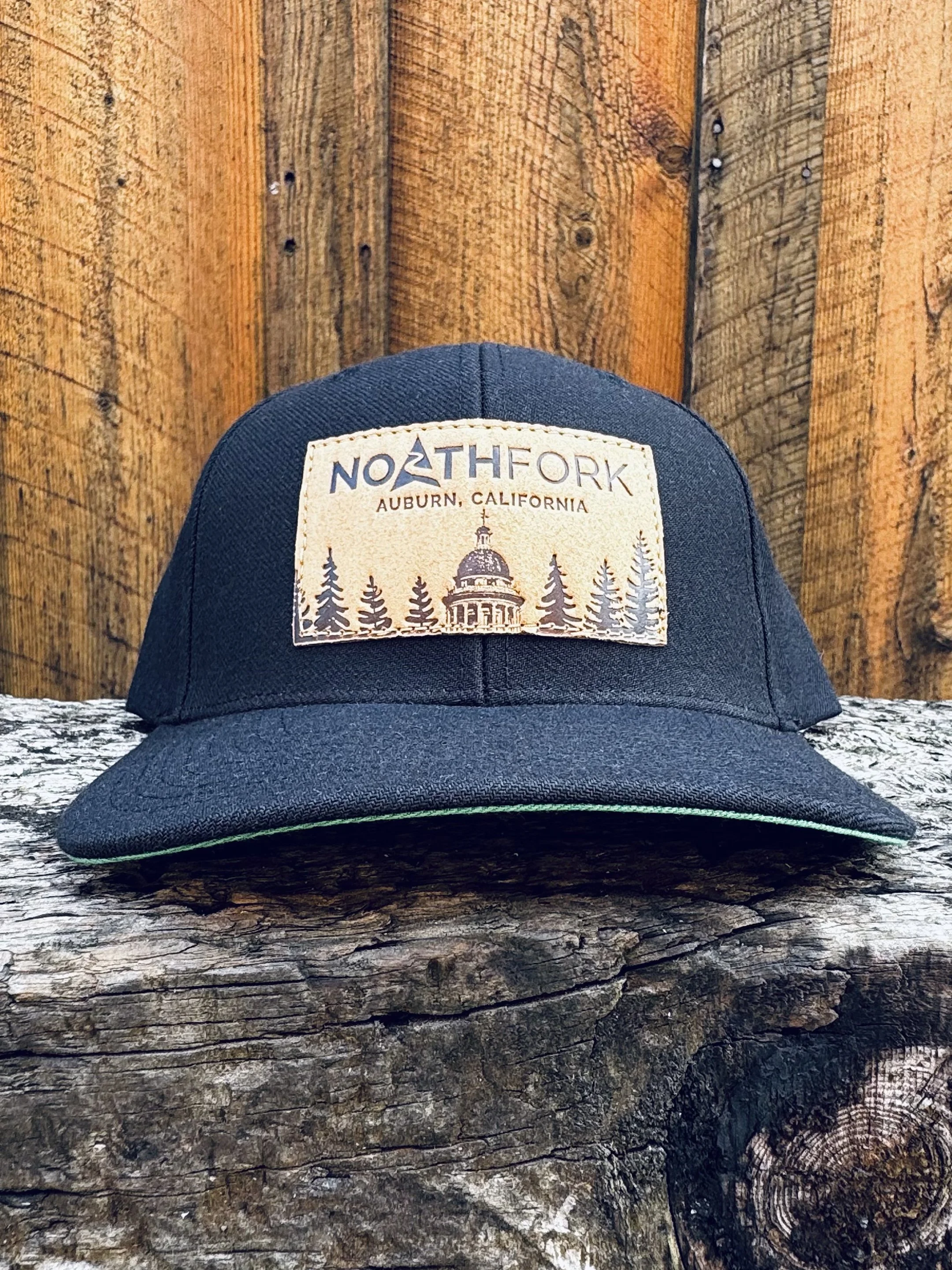 CourthouseLeatherPatchHat-Black-WoodBG.jpg