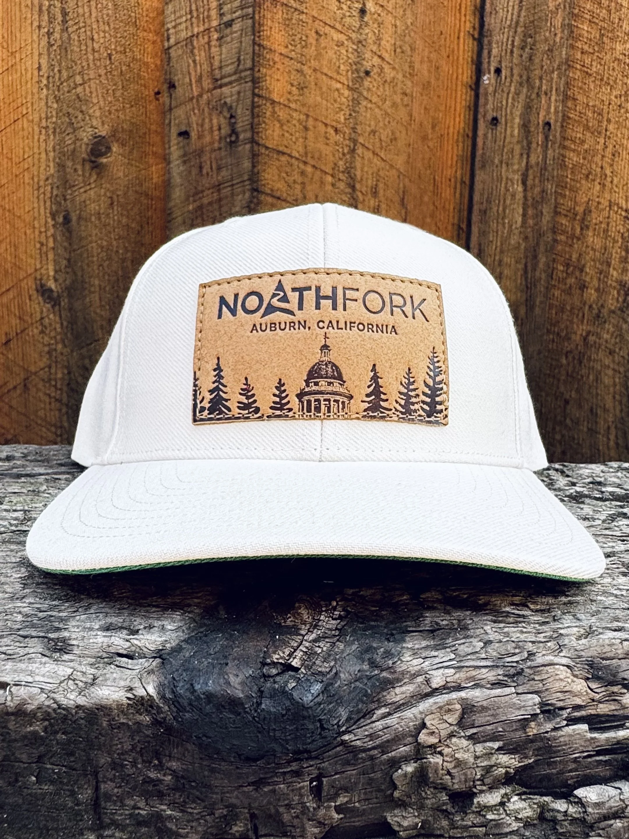 CourthouseLeatherPatchHat-Ivory-WoodBG.jpg