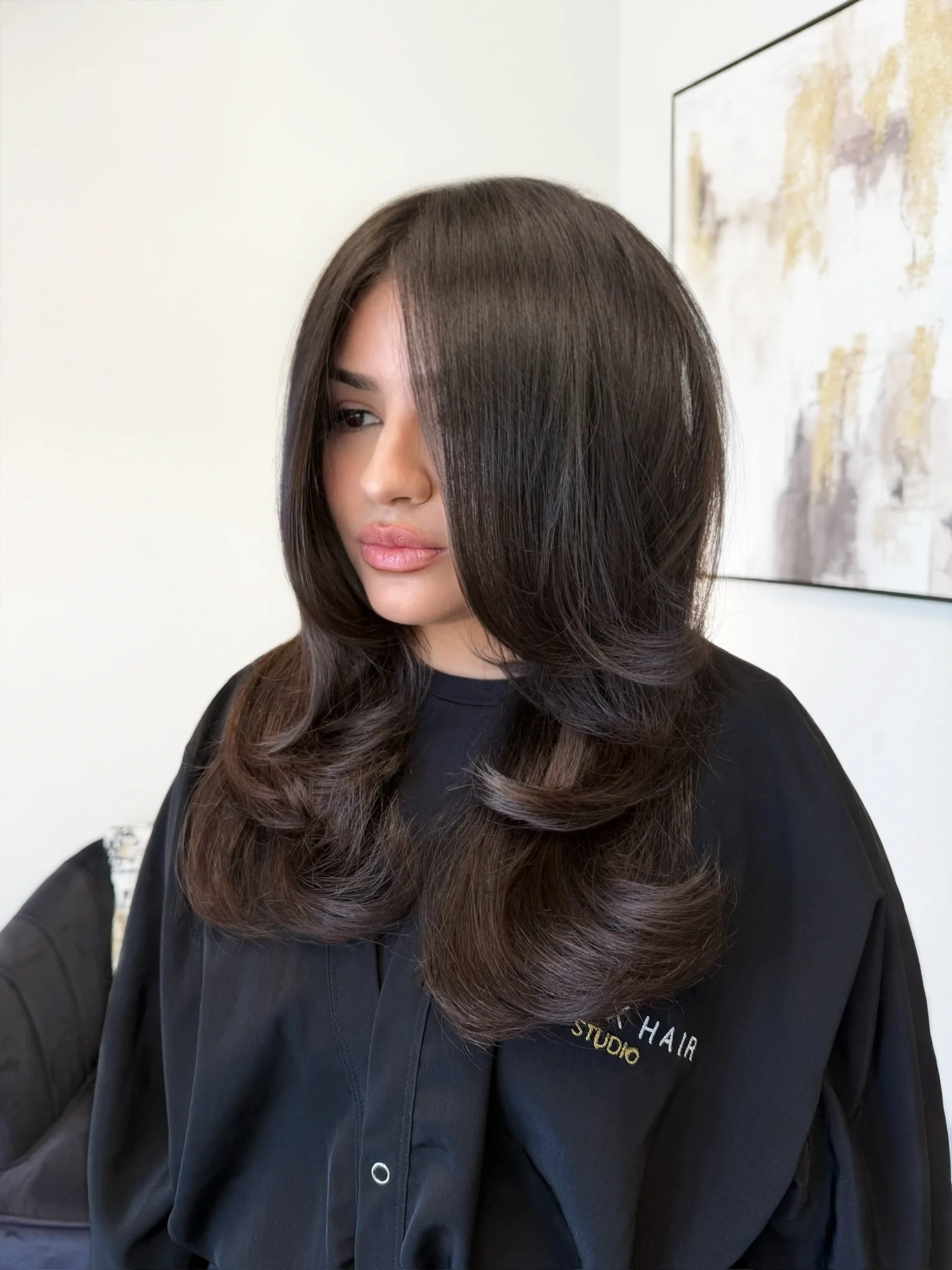 Women’s layered haircut with glossy bombshell blowout on dark brunette hair by Ivan at Ivan X Hair in Kennewick, WA
