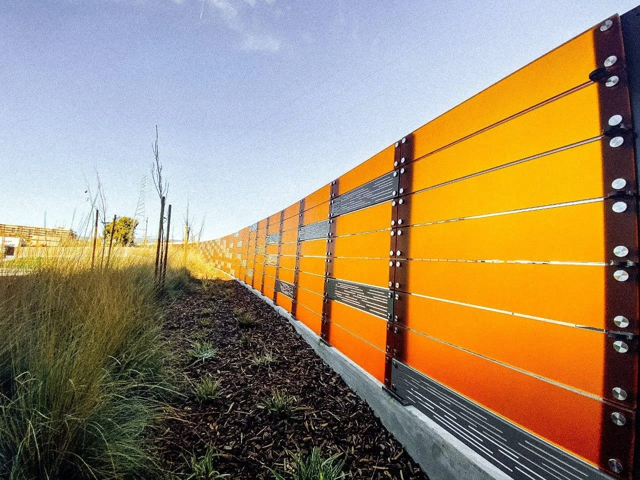 Acrylic panels create a striking edge between the planted area and track space.