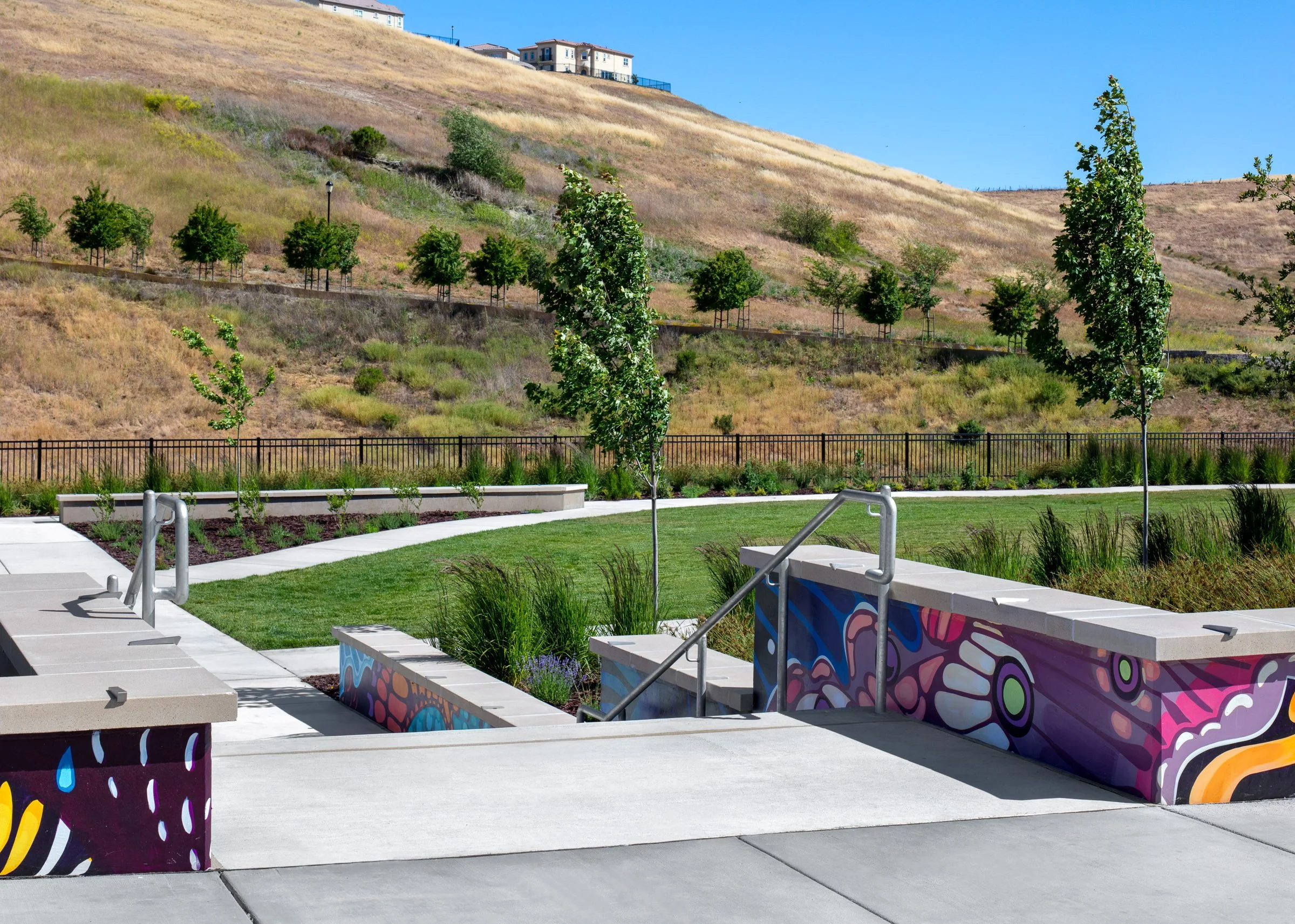 Grand entry staircase, adorned with a butterfly mural created by artist Joey Rose in collaboration with neighborhood residents