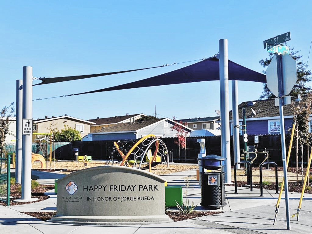 The park entry combines clear sightlines, integrated site furnishings, and open community space to create a welcoming neighborhood destination.