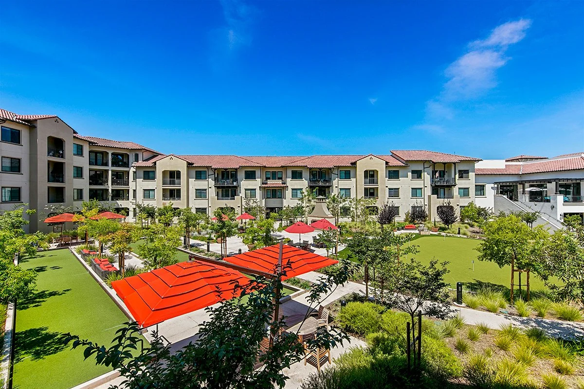 Comfortable seating areas with shade surround bocce courts and a putting green.