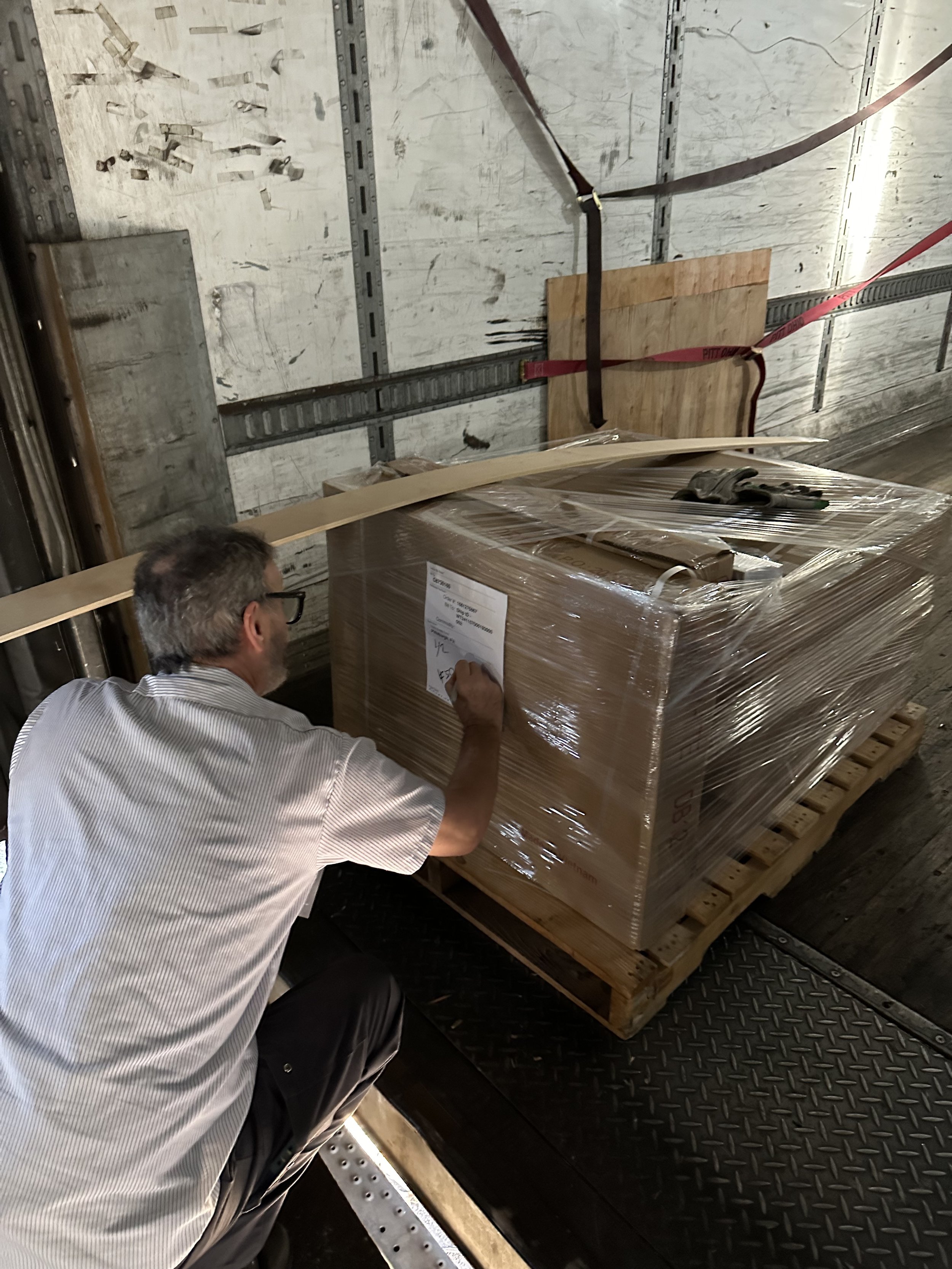 Workers packaging RTA cabinets for shipment from U.S. warehouse