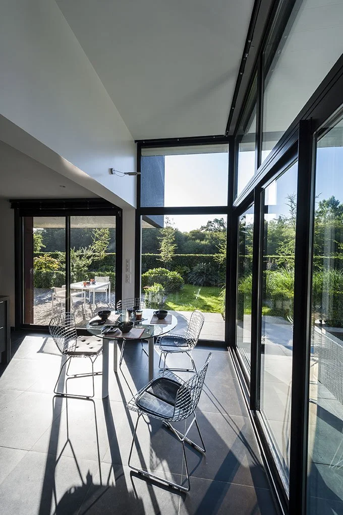 Vues sur le jardin depuis l'intérieur d'une habitation contemporaine à Rennes.