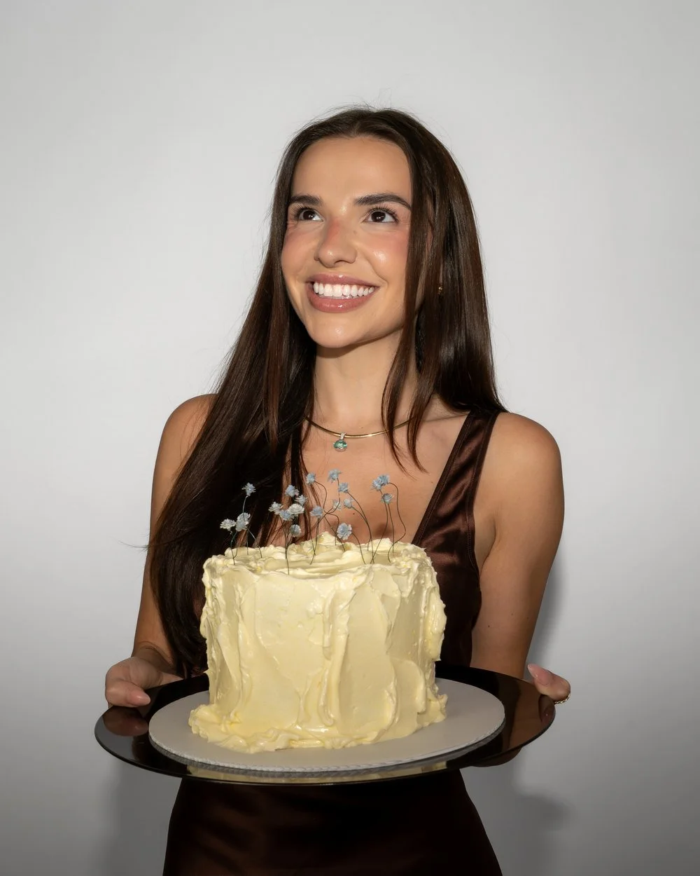 Catherine Lockhart holding a white frosted cake