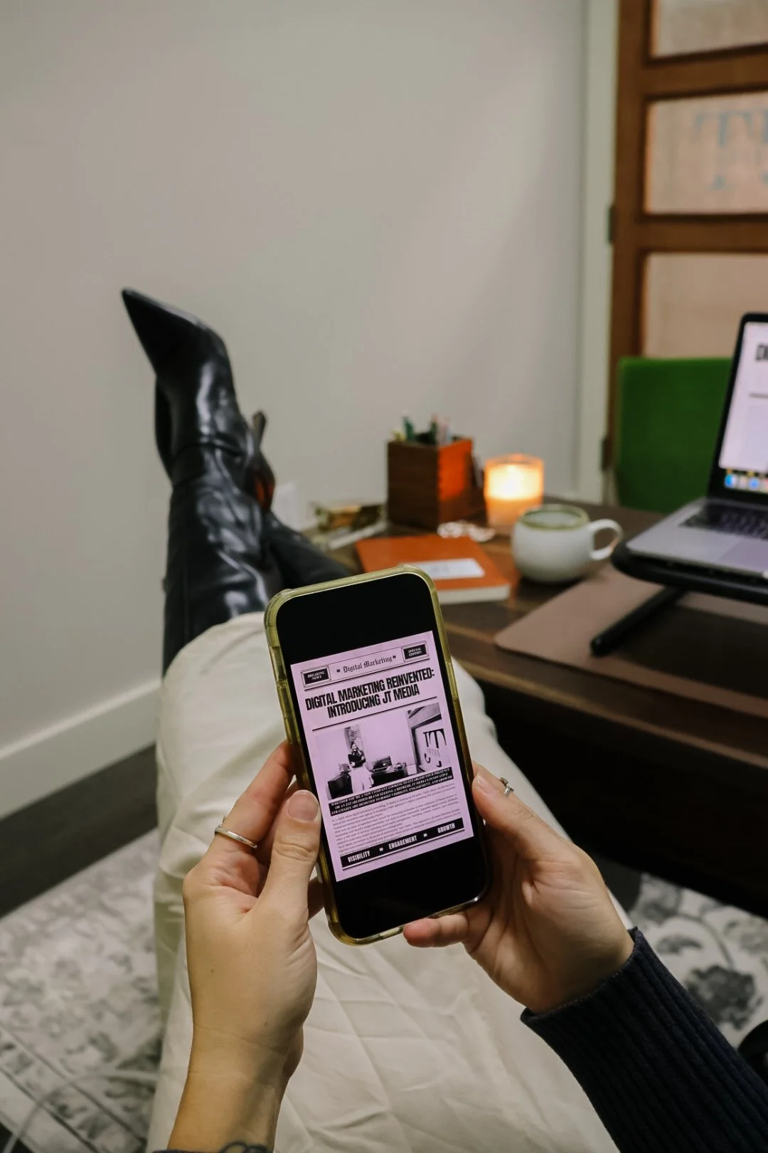 Woman owned business holding phone that says "digital marketing reinvented"