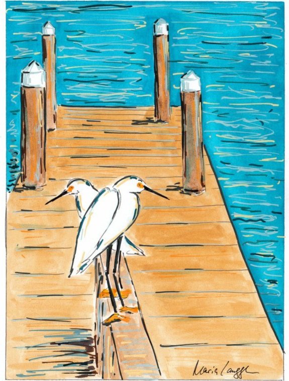 Two white herons standing on a wooden dock by a body of water.