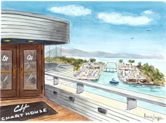 Waterfront scene viewed from a deck or balcony with a railing. A boat is on the water near a bridge, and there are buildings and trees on the opposite riverbank. The sky is partly cloudy.