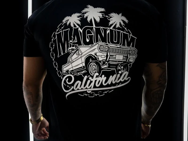 Back of a black t-shirt with "MAGNUM California" graphic featuring a classic car and palm trees in white design.