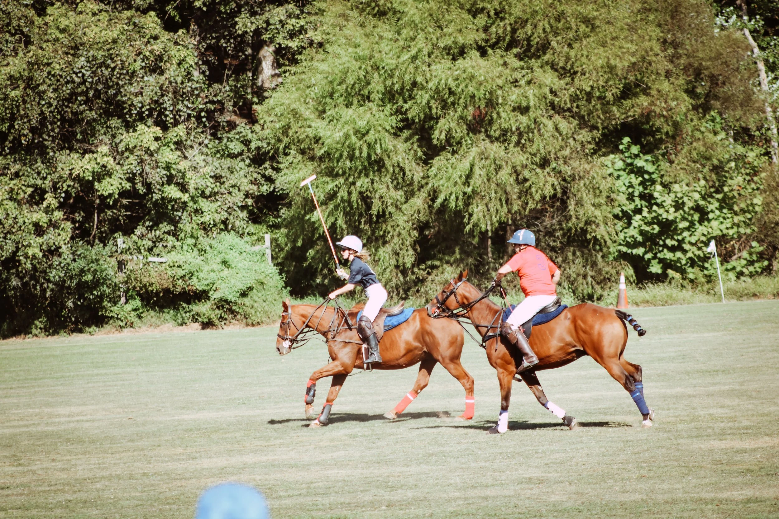 Two players on horseback complete in the 2025 Charity Polo Cup.
