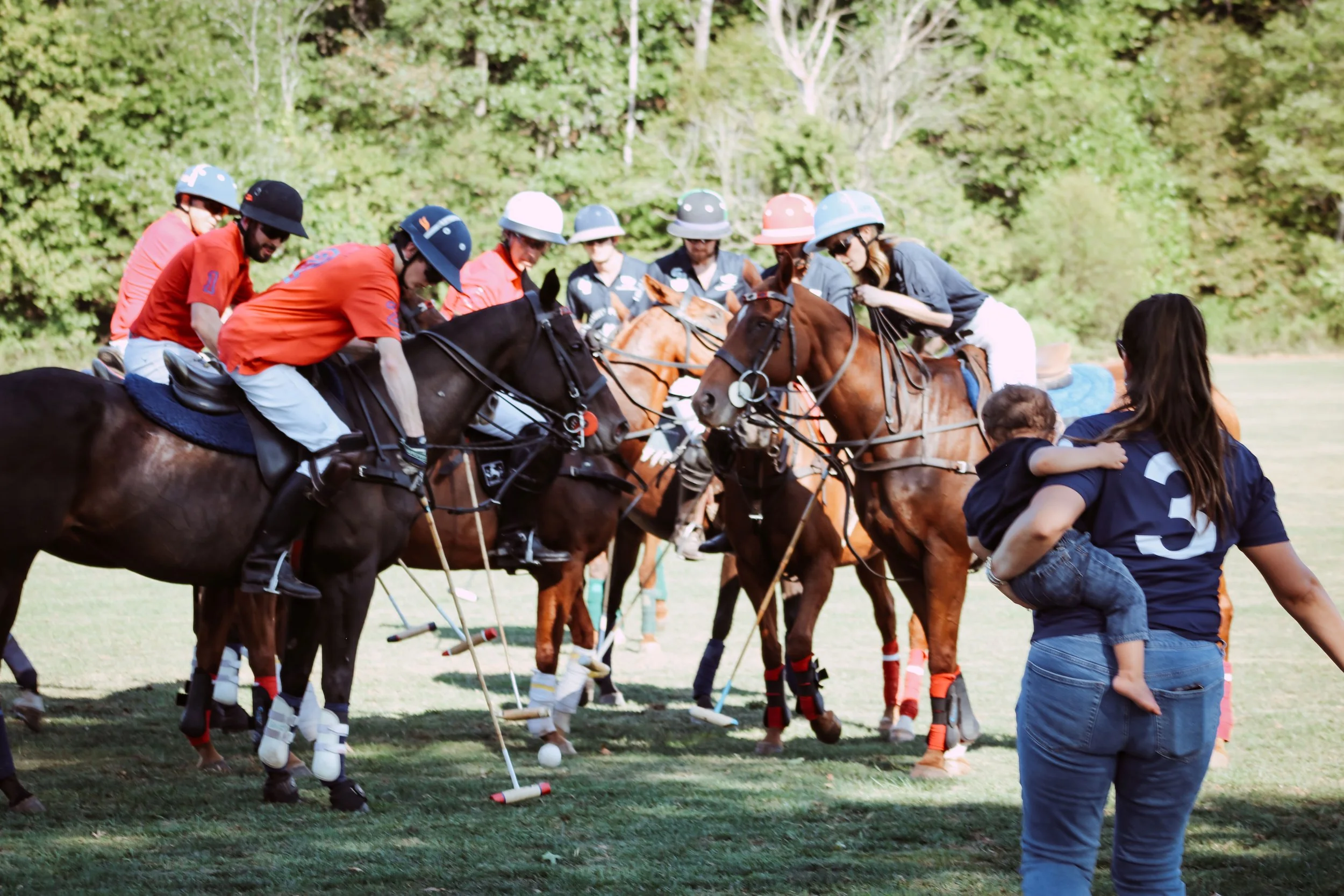 Players on horseback begin the polo match at the 2025 Charity Polo Cup.