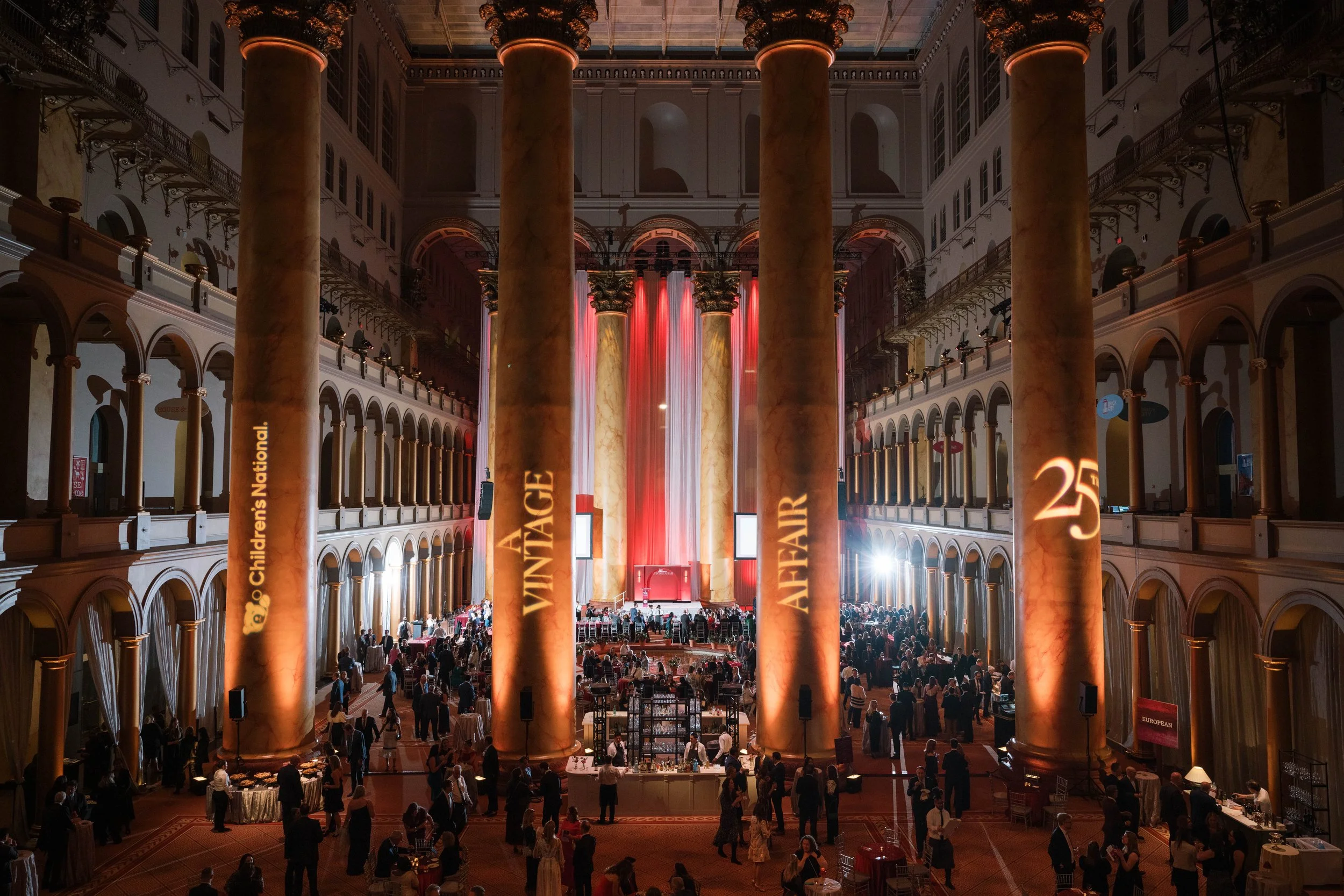 A bird's eye view of A Vintage Affair 2024 attendees gathered within the National Building Museum.