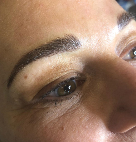 Close-up of a person's face focusing on the left eye and eyebrow, showing natural skin texture and facial features.