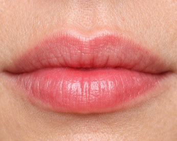 Close-up of a person's lips with natural pink color.