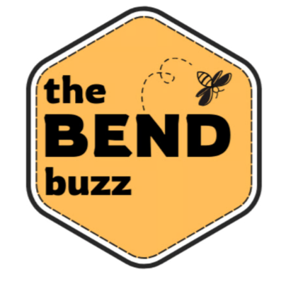 Logo with a honeycomb shape background, featuring the text 'the BEND buzz' and a bee flying near the top.