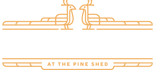 Logo for Dogwood at the Pine Shed featuring stylized dog silhouettes and decorative lines.