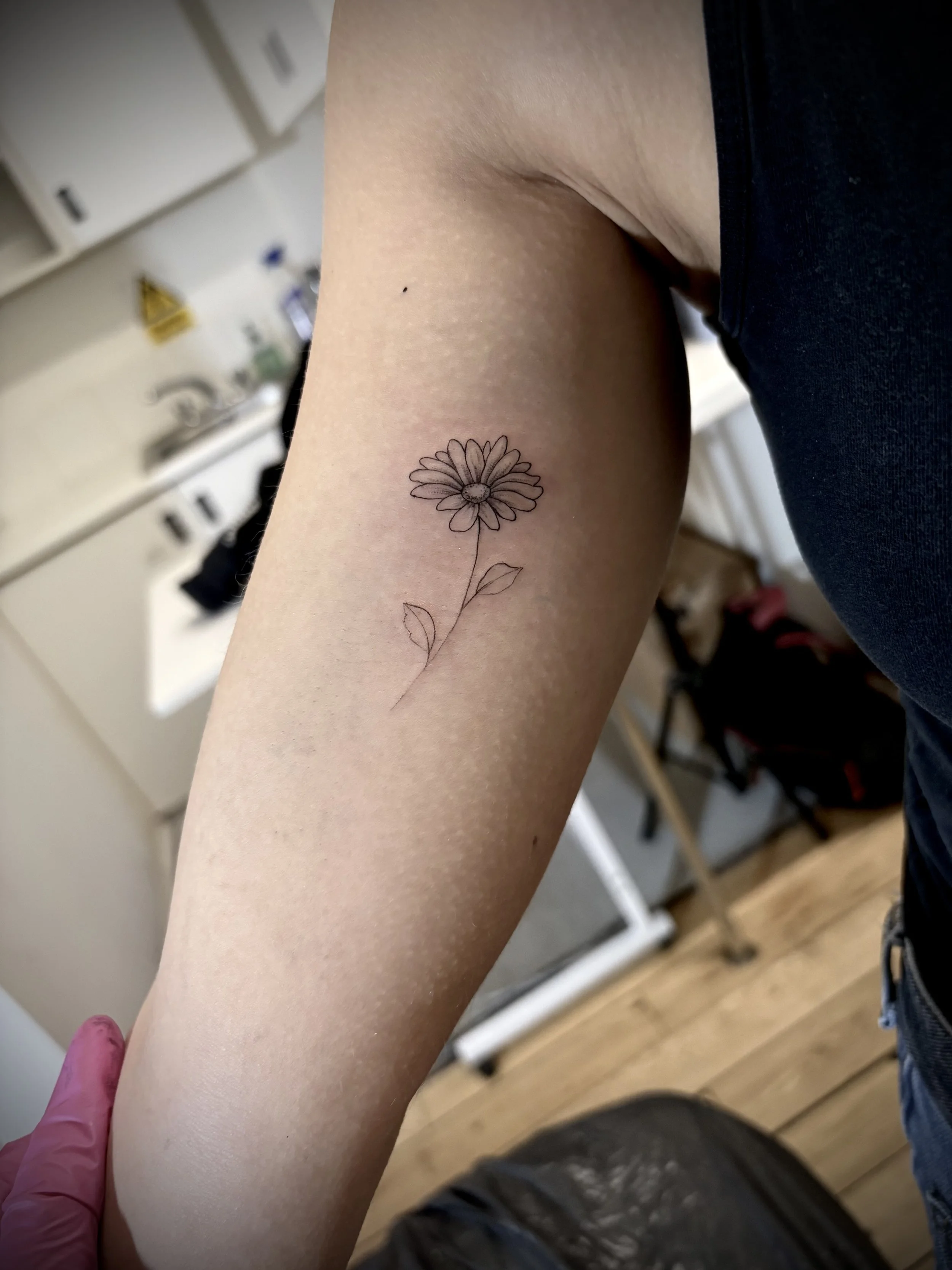 Fine line floral tattoo