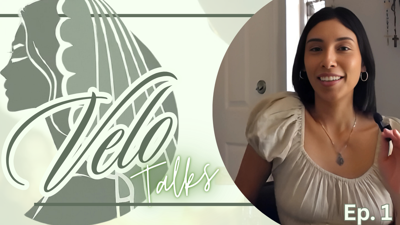 A woman with long dark hair smiling and holding a microphone, sitting indoors near a window, with religious crosses on the wall behind her. The image is part of a logo or thumbnail for a talk show titled "Hello Talks," Episode 1.
