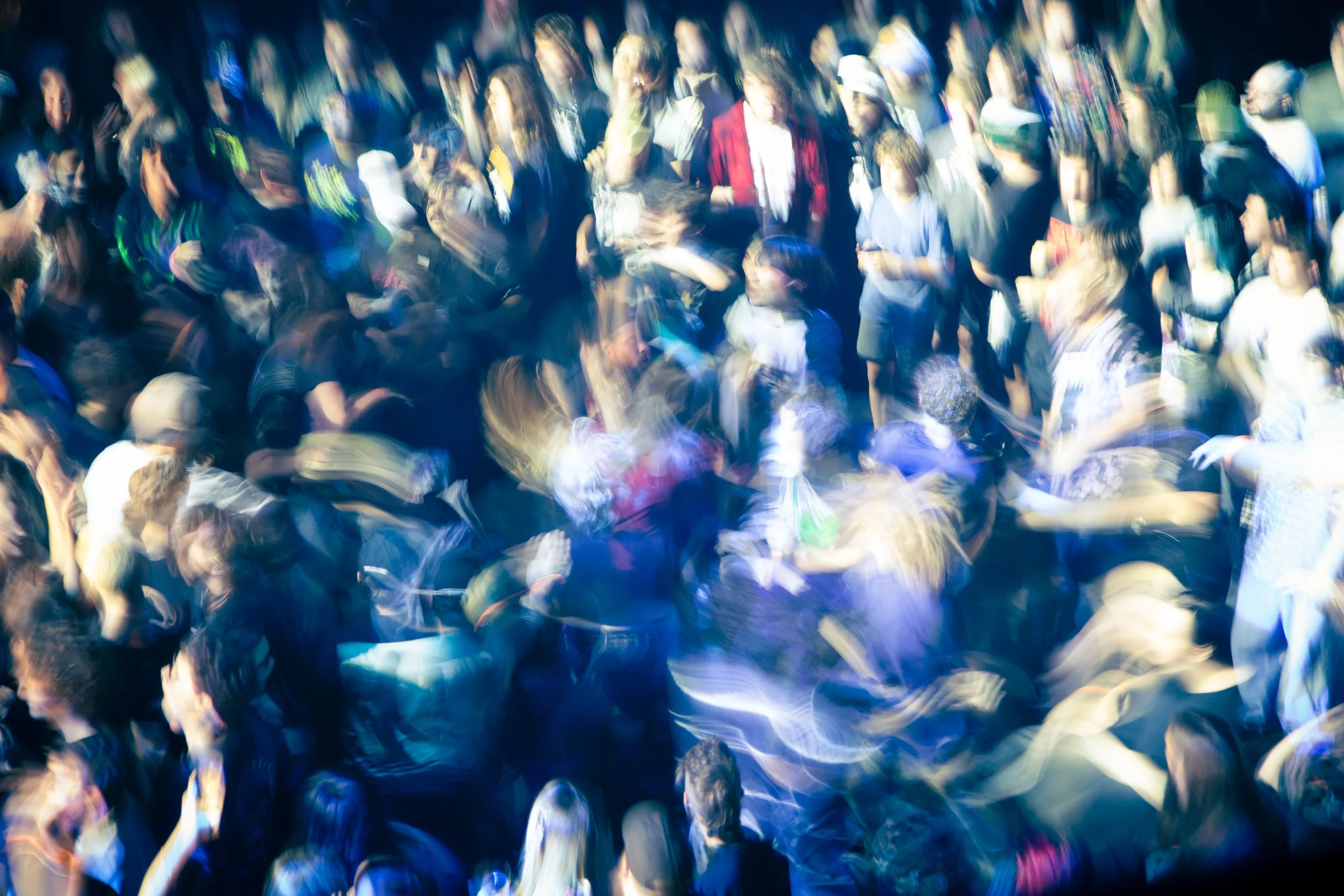 Blurred crowd of people moshing at a Superheaven concert, at Brooklyn Bowl Nashville. 