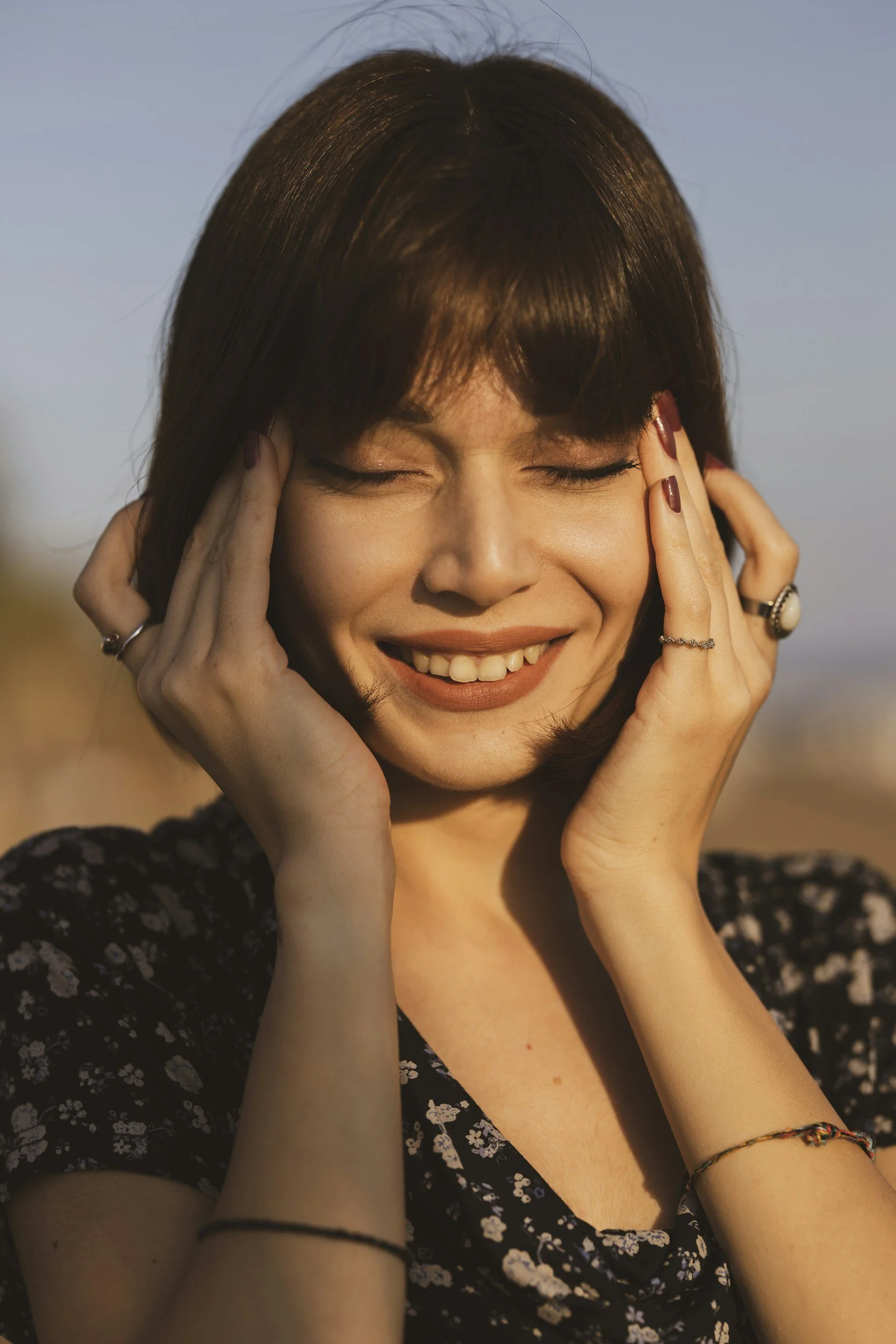 woman smiling with hands on face happy to not have anxiety