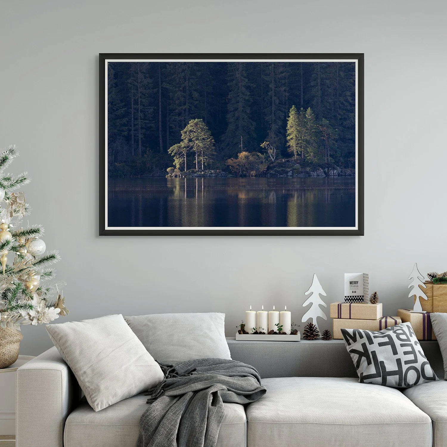 Dark moody Fine Art Photography of trees mirrored in a loch, within a cosy lounge setting decorated for Christmas.