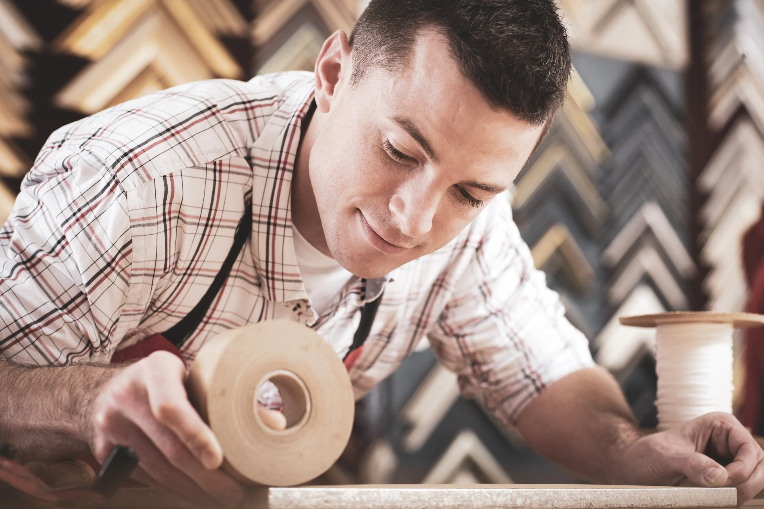 A man finishing a frame in his workshop