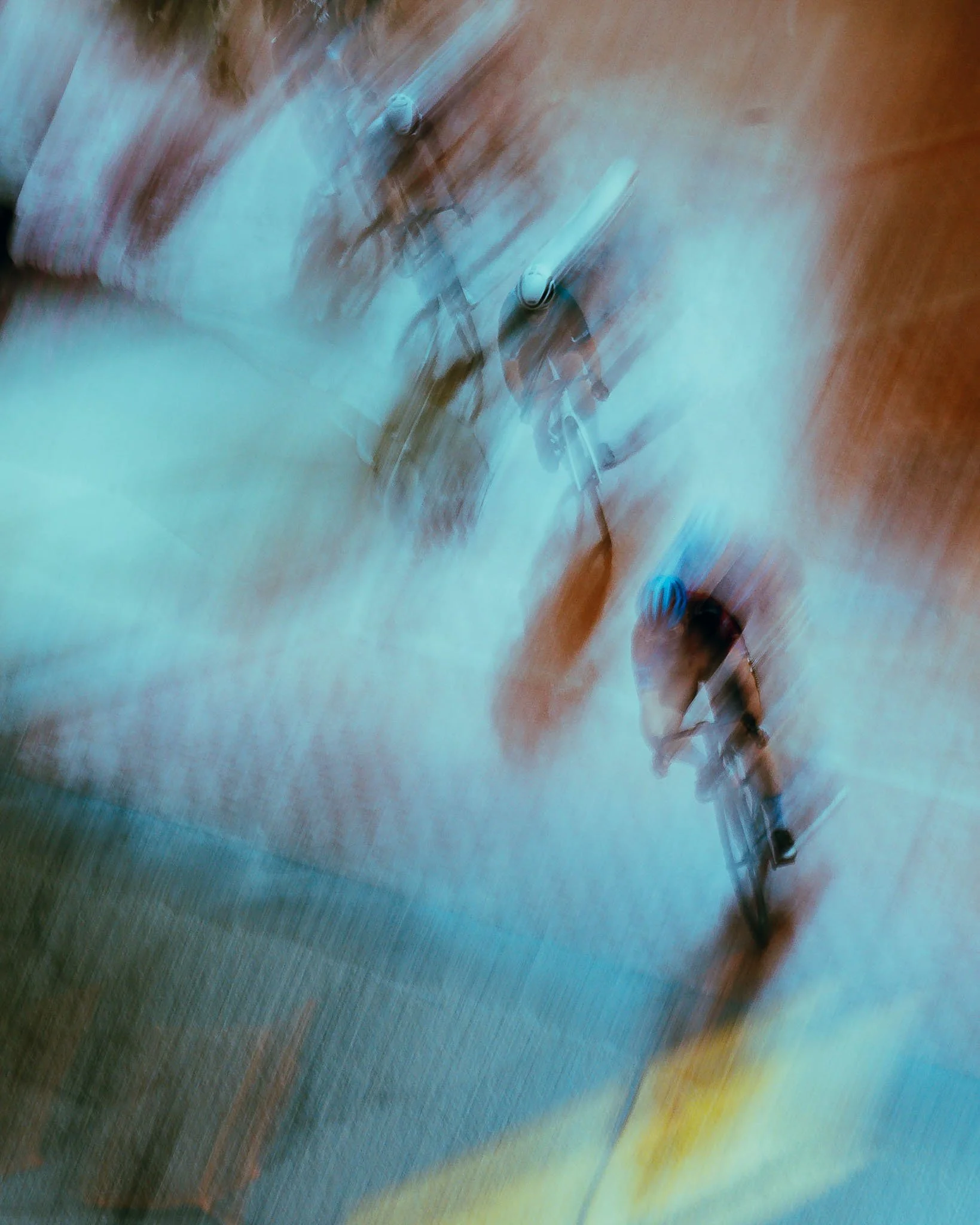 Blurred image of a person walking on a colorful, illuminated surface with streaks of light and motion.